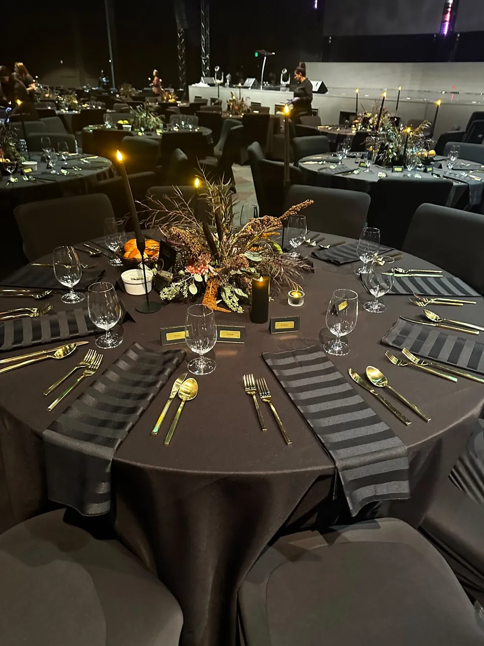 Evening gala table with charcoal linen and striped runners
