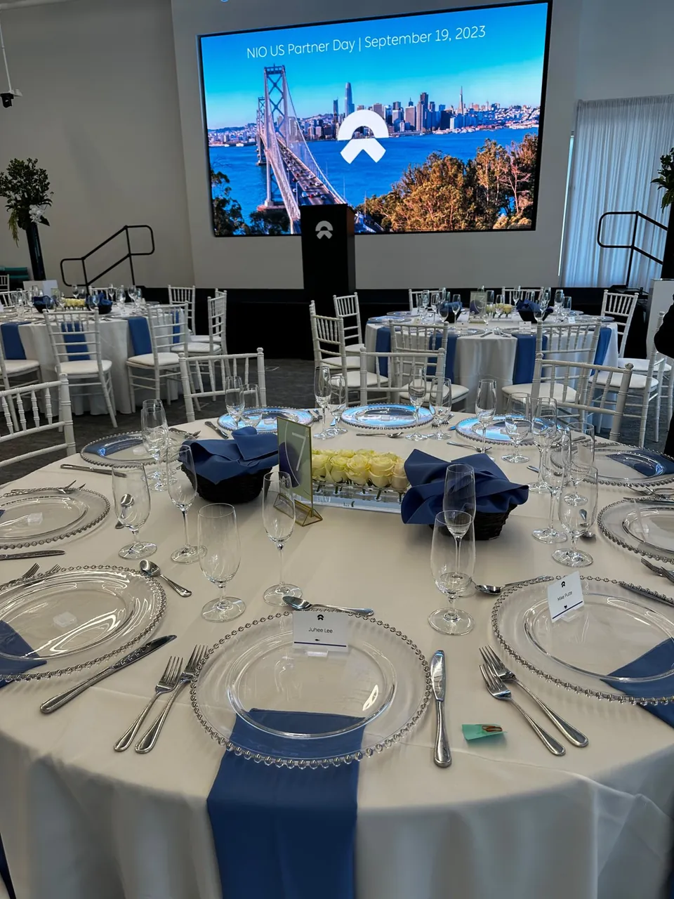 Round table set for a corporate meeting with navy napkins