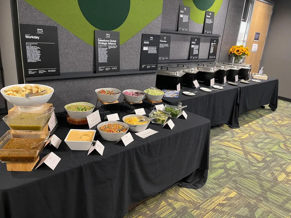Salad and grain buffet on black linen in a company meeting space