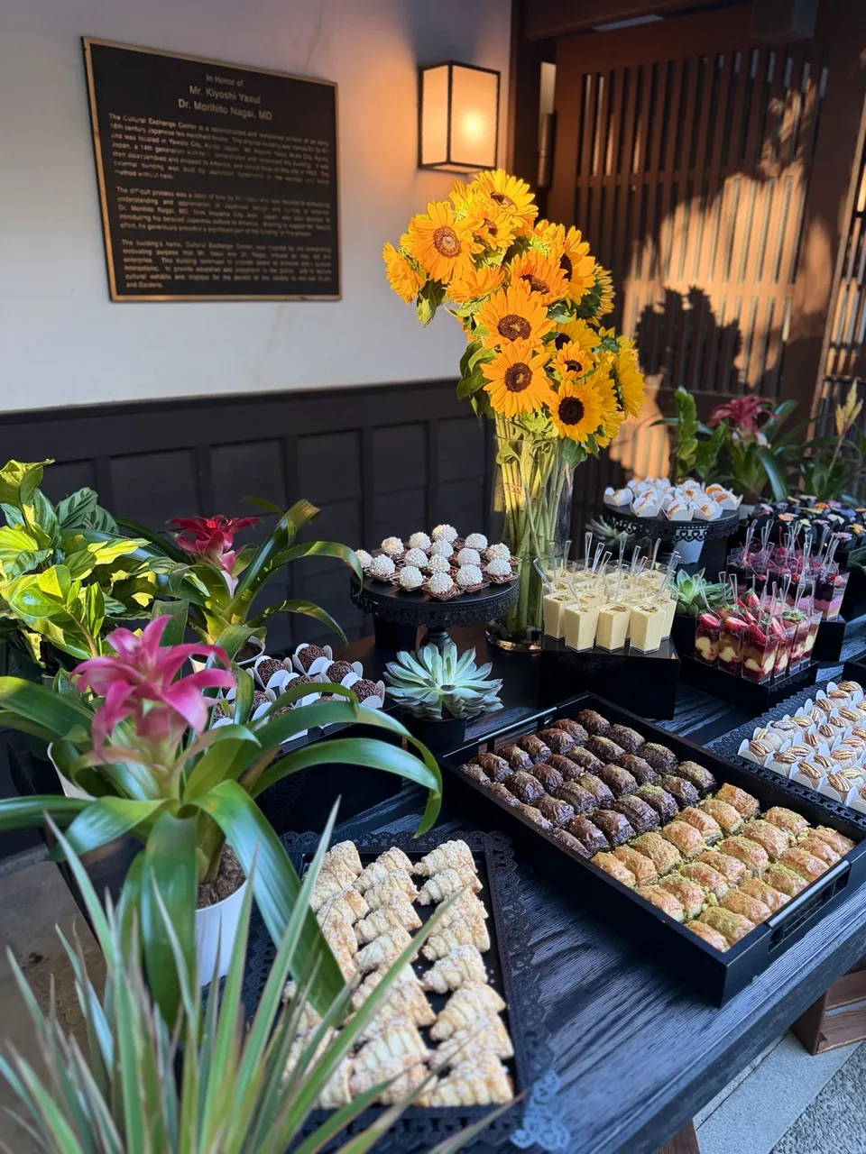 Dessert bites and sweet pastries beside sunflowers