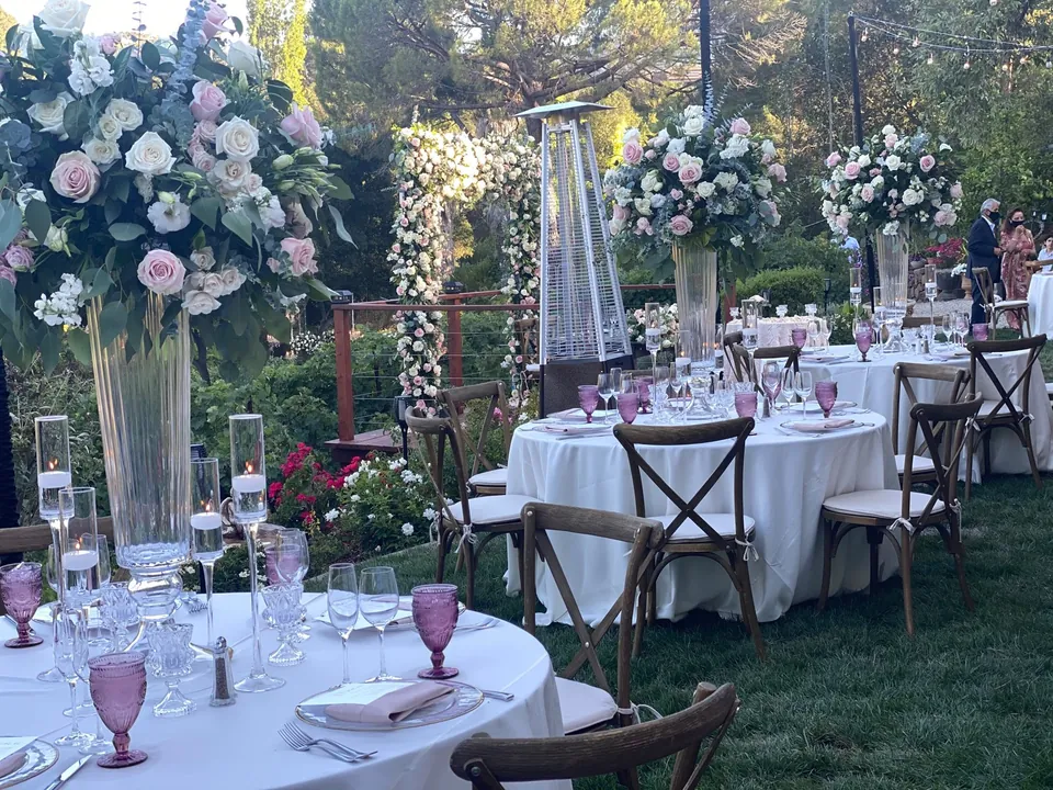 Garden reception with tall pink and white floral arrangements