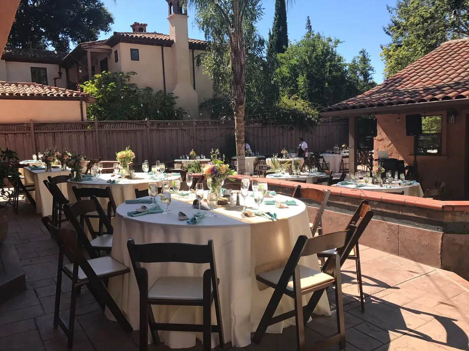 Round tables set in a Spanish style courtyard